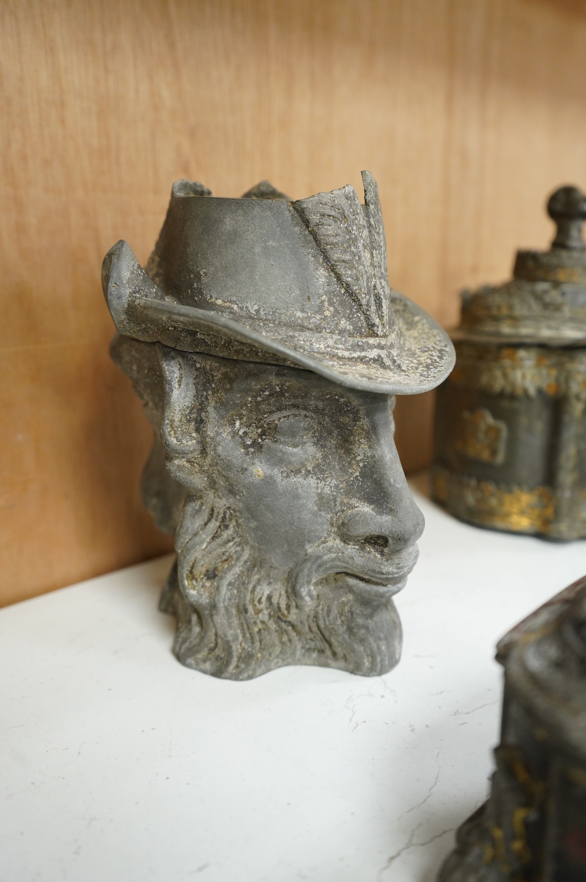 A collection of ten early 19th century lead tobacco boxes, one in the form of a goat’s head, tallest 20cm
